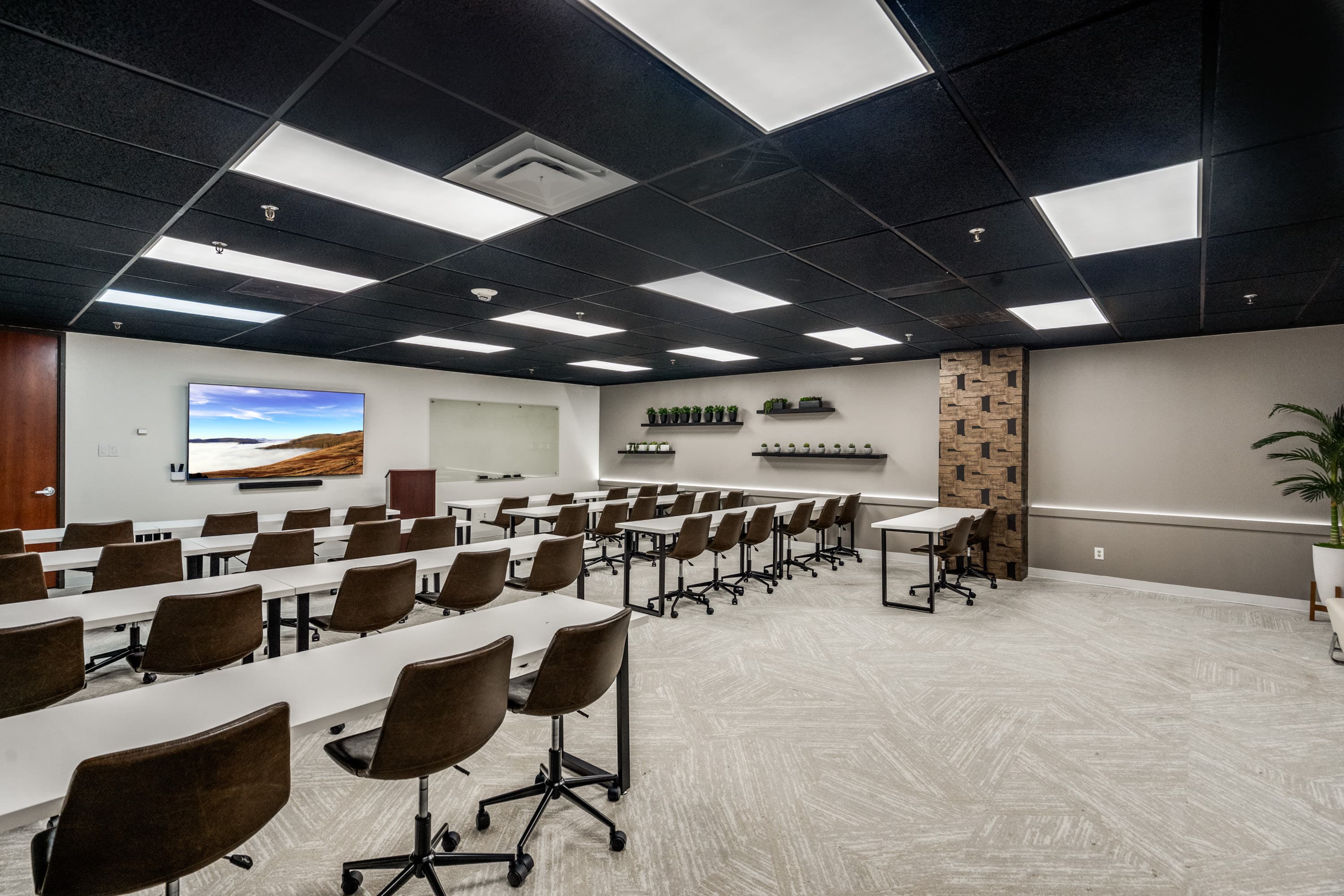 Training room with screenshare television, a dry-erase board, and classroom style seating