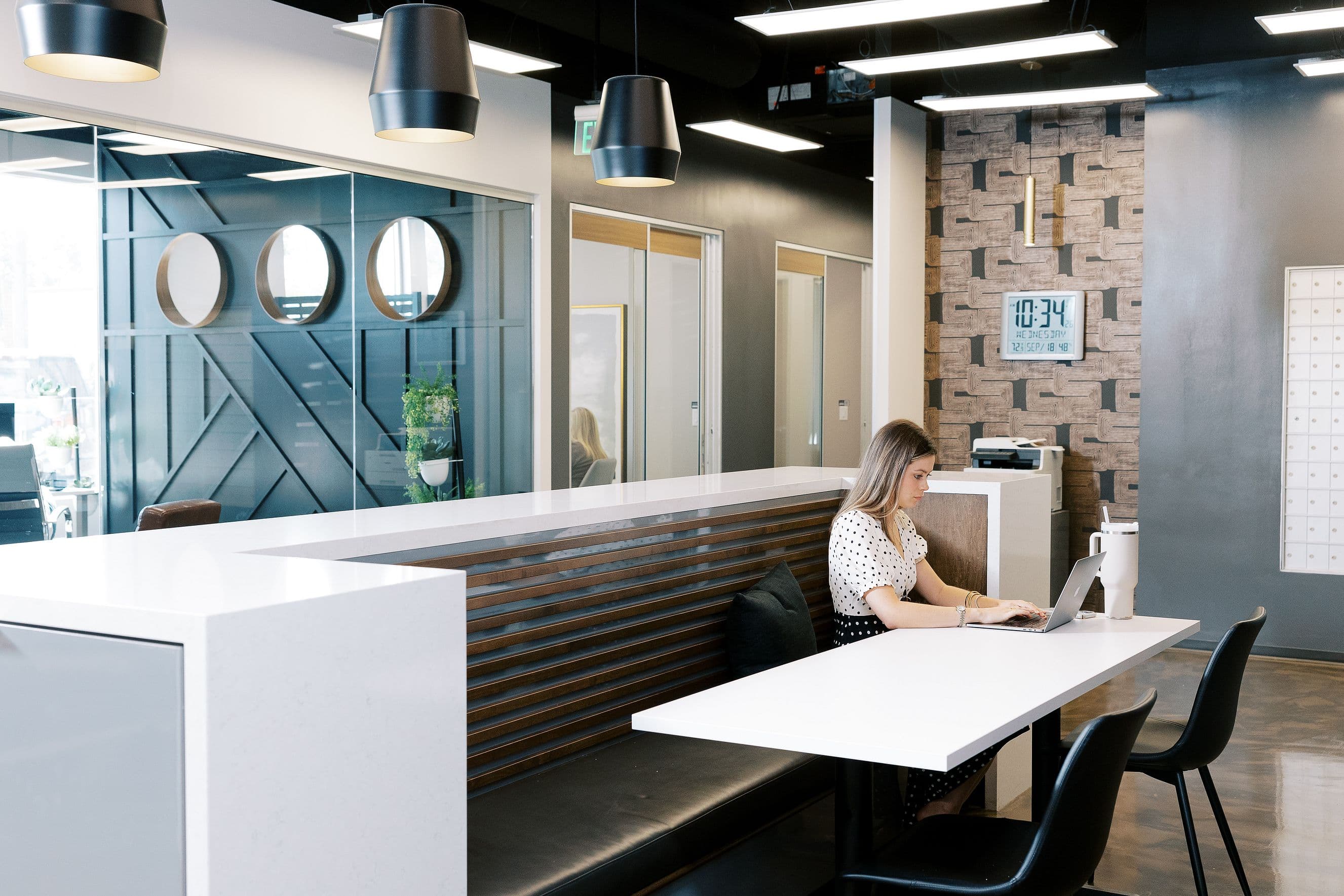 Woman working at a hot desk table at Lucid Private Offices